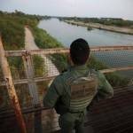 A U.S. border patrol agent looks over the Rio Grande at the border between the United States and Mexico, in Roma, Texas. The Supreme Court ruled on Monday that a U.S. border patrol officer accused of shooting a 15-year-old Mexican on Mexican soil has to stand trial. CARLOS BARRIA/REUTERS