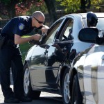 A Sacramento Police officer makes a traffic stop in November 2012. Gov. Jerry Brown signed a bill in June to end the practice of Californians losing their driver’s license because of unpaid traffic fines. Photo Credit: Rich Pedroncelli / AP as reported by Los Angeles Times, 6/29/17.
